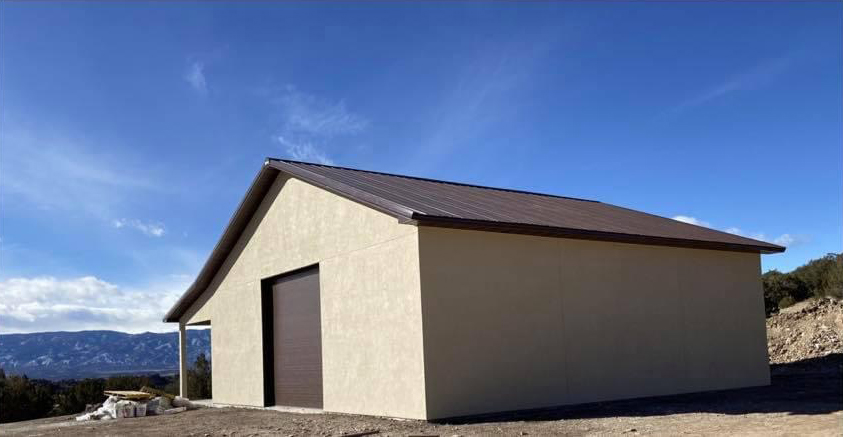 White and brown post frame suburban building with a front porch and awning from Fat Puppy Construction