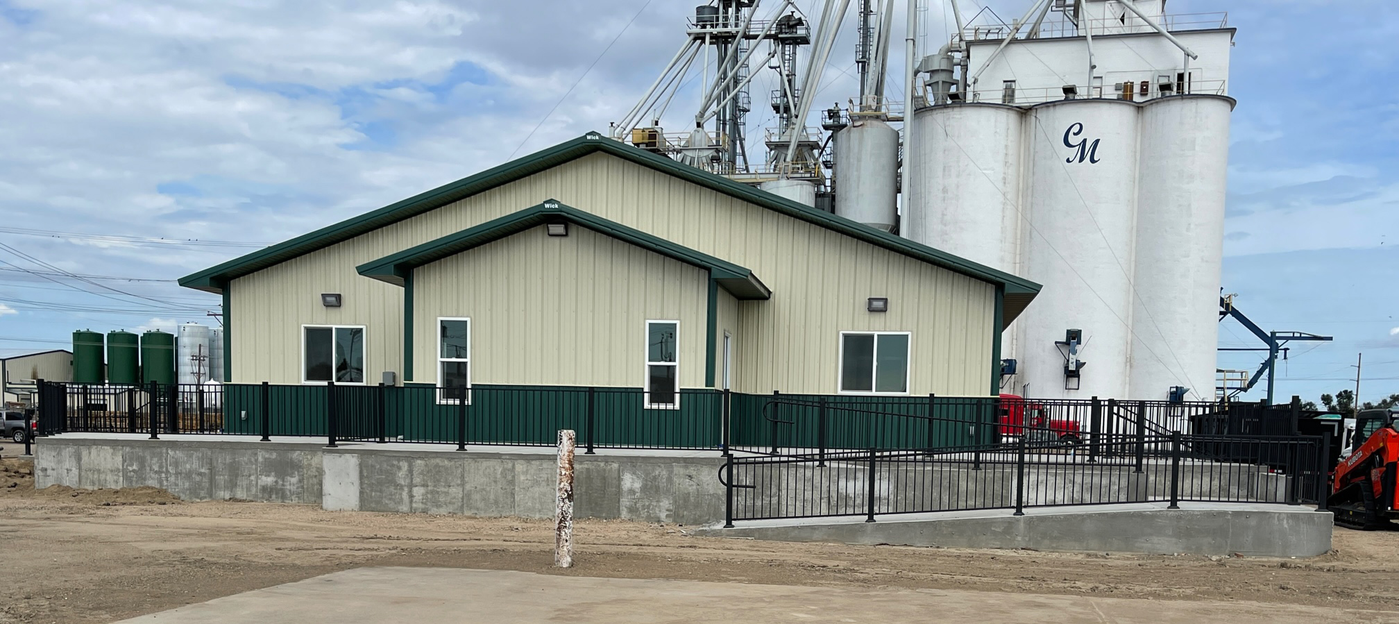 Fat Puppy Construction featured project: green and yellow post frame commercial building