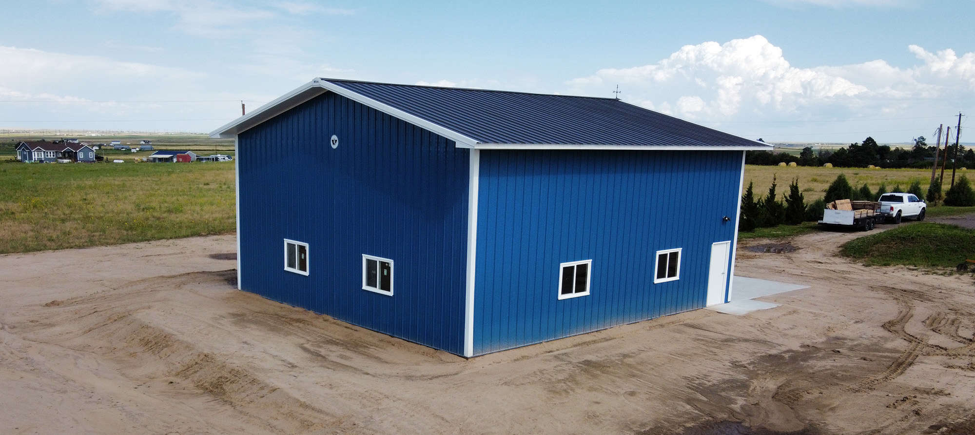 Fat Puppy Construction featured project: blue and white post frame suburban workshop